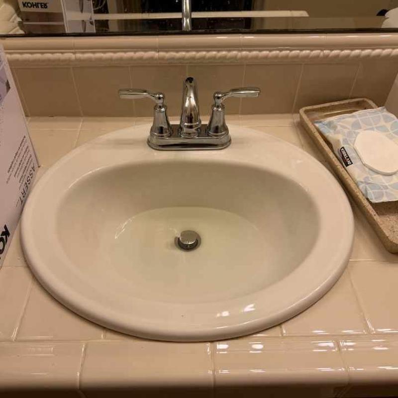 Bathroom lavatory faucet with chrome handles installed