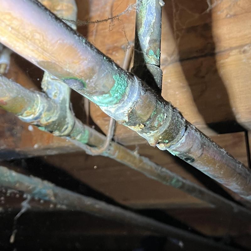 Corroded copper water pipes under basement floor joists Corroded copper water pipes under basement floor joists