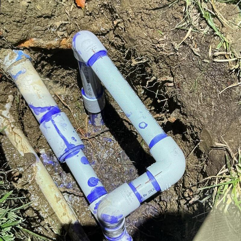1-inch PVC plumbing pipe with fittings in soil excavation