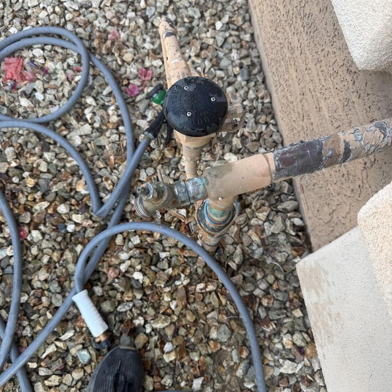 Hose bib installation with leaking pipe in gravel area
