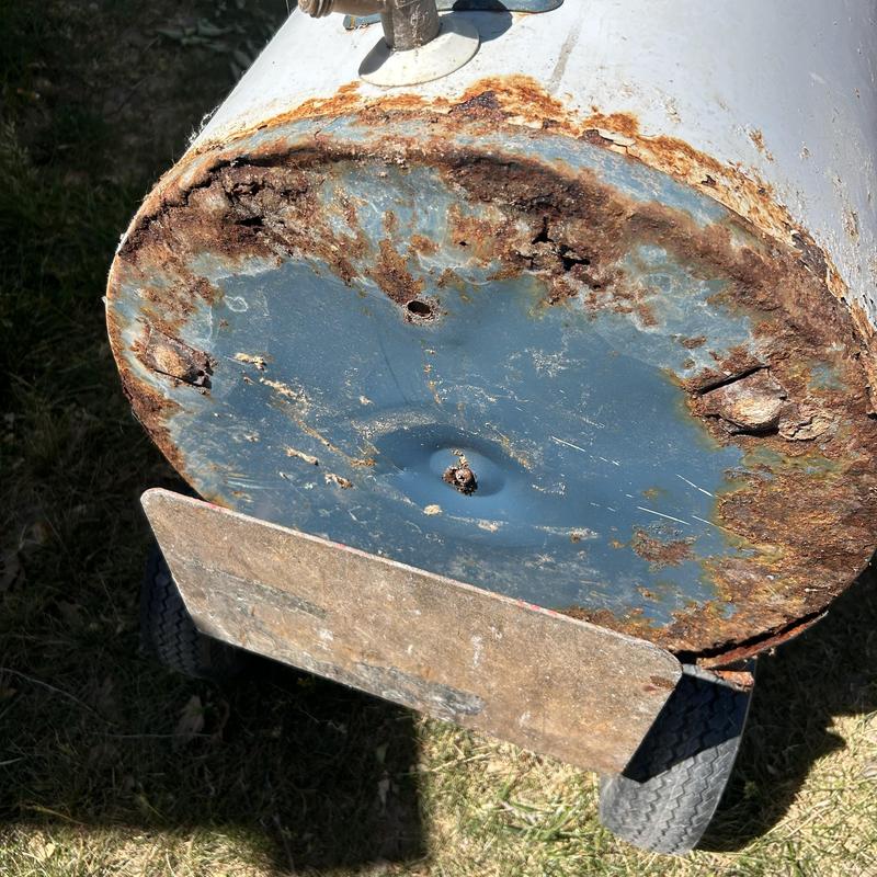 Water heater base corrosion and rust damage close-up Water heater base corrosion and rust damage close-up