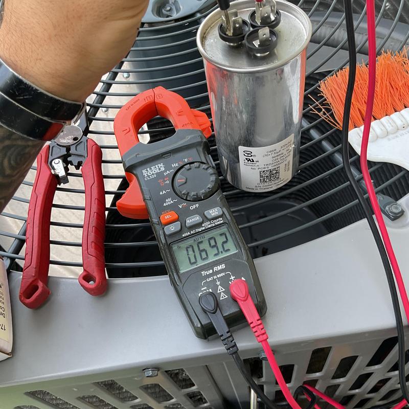 HVAC capacitor testing with digital clamp meter on unit HVAC capacitor testing with digital clamp meter on unit