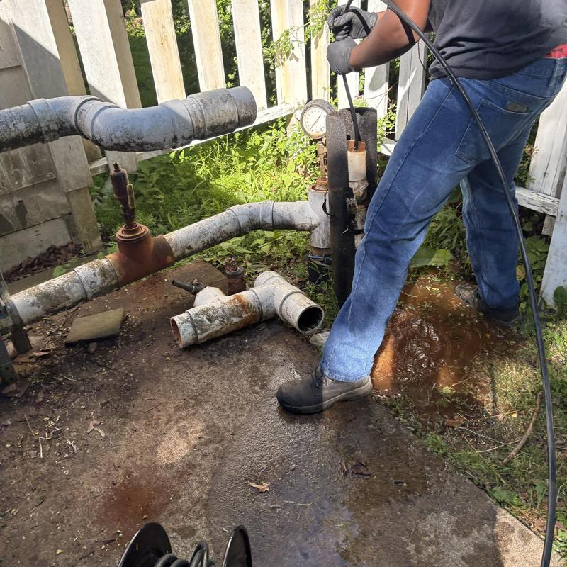 Water pipe jetting with hose and pressure gauge outdoors Water pipe jetting with hose and pressure gauge outdoors