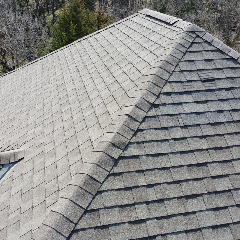 Asphalt shingle roof with repaired wind damage
