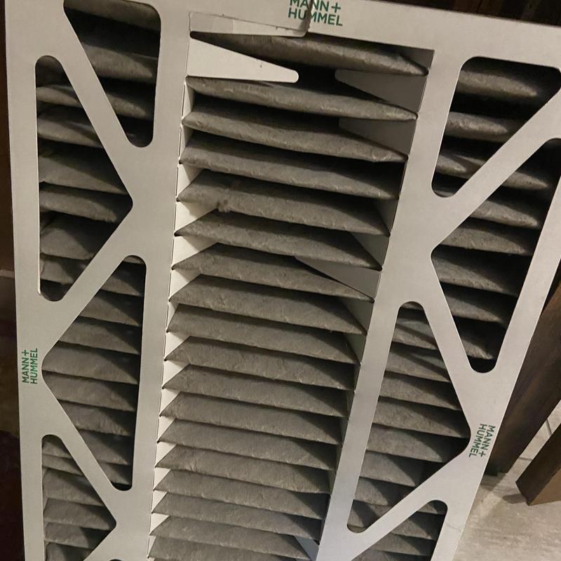 HVAC air filter with dust buildup inside frame HVAC air filter with dust buildup inside frame