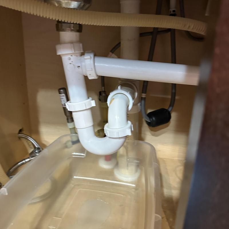 Kitchen sink drain pipes and trap under cabinet