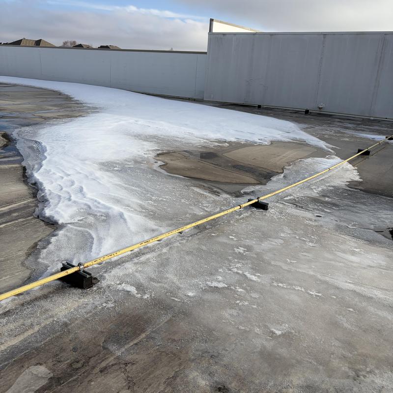 Single ply drain foam test on flat roof surface
