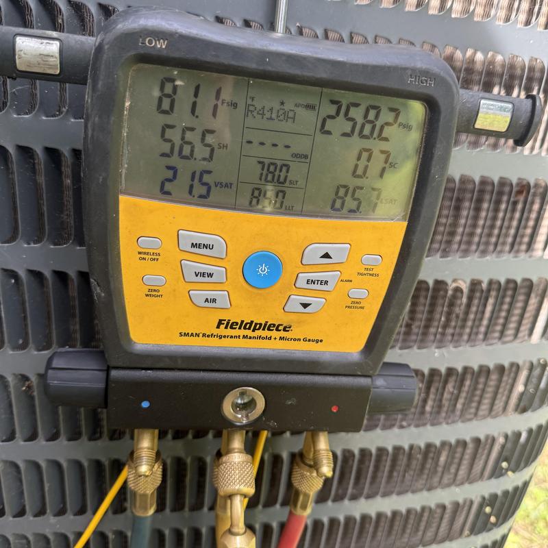 Refrigerant manifold gauge on AC condenser unit Refrigerant manifold gauge on AC condenser unit