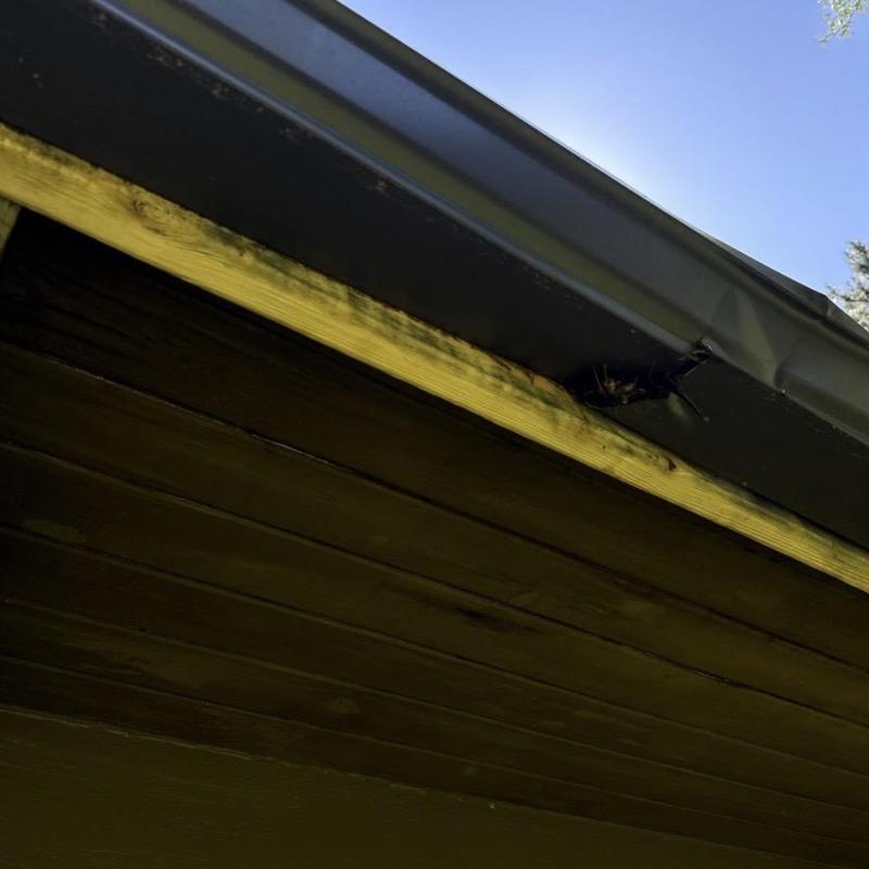 Aluminum gutter with water damage on fascia board Aluminum gutter with water damage on fascia board