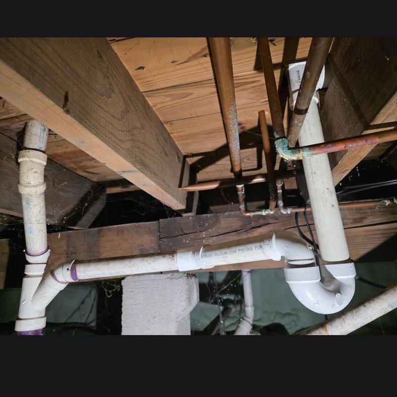 PVC drain pipe installation under basement joists
