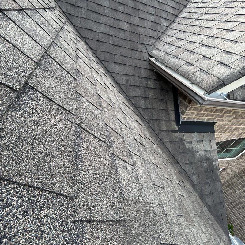 Asphalt shingle roof with ridge vent and flashing inspection