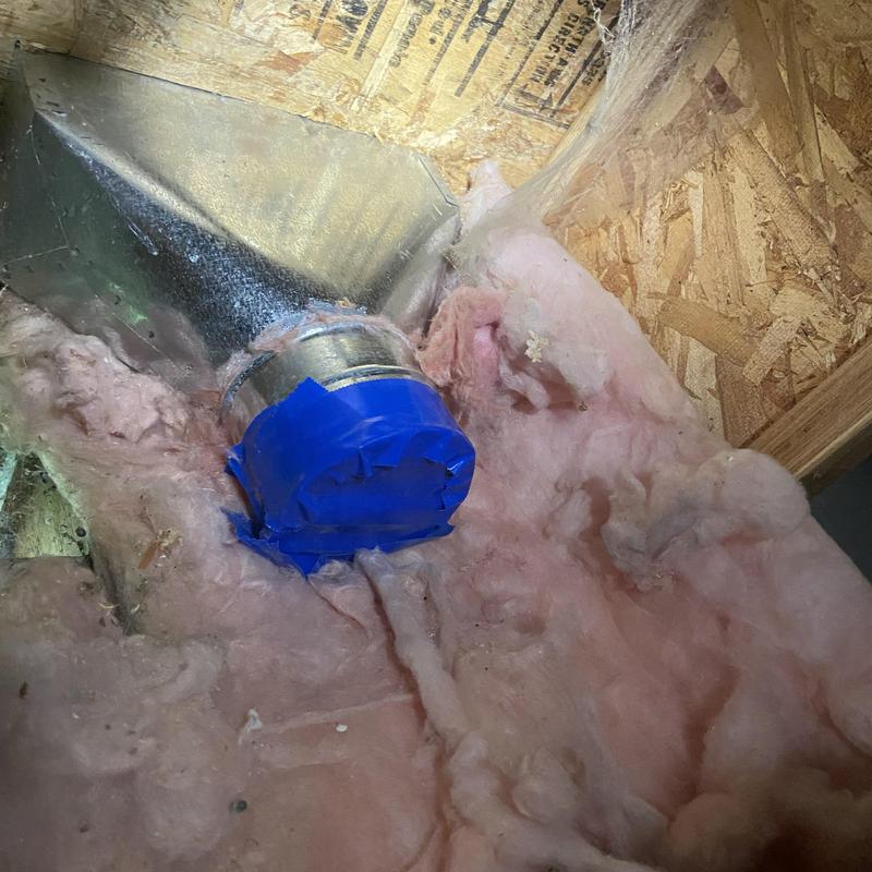 Ductwork sealed with blue tape in attic insulation Ductwork sealed with blue tape in attic insulation