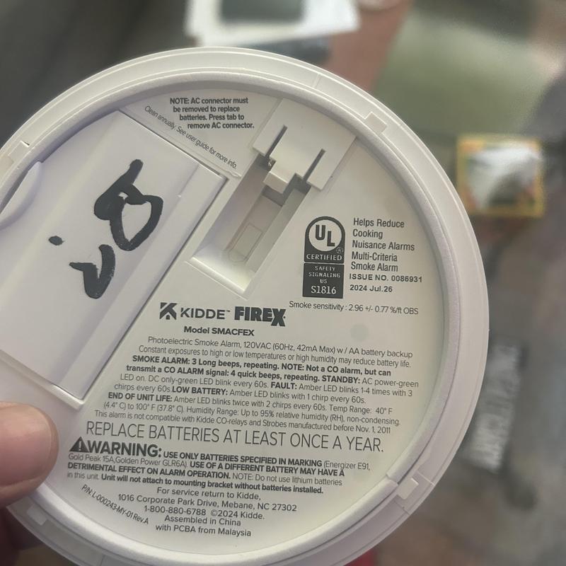Smoke detector battery replacement warning label close-up Smoke detector battery replacement warning label close-up