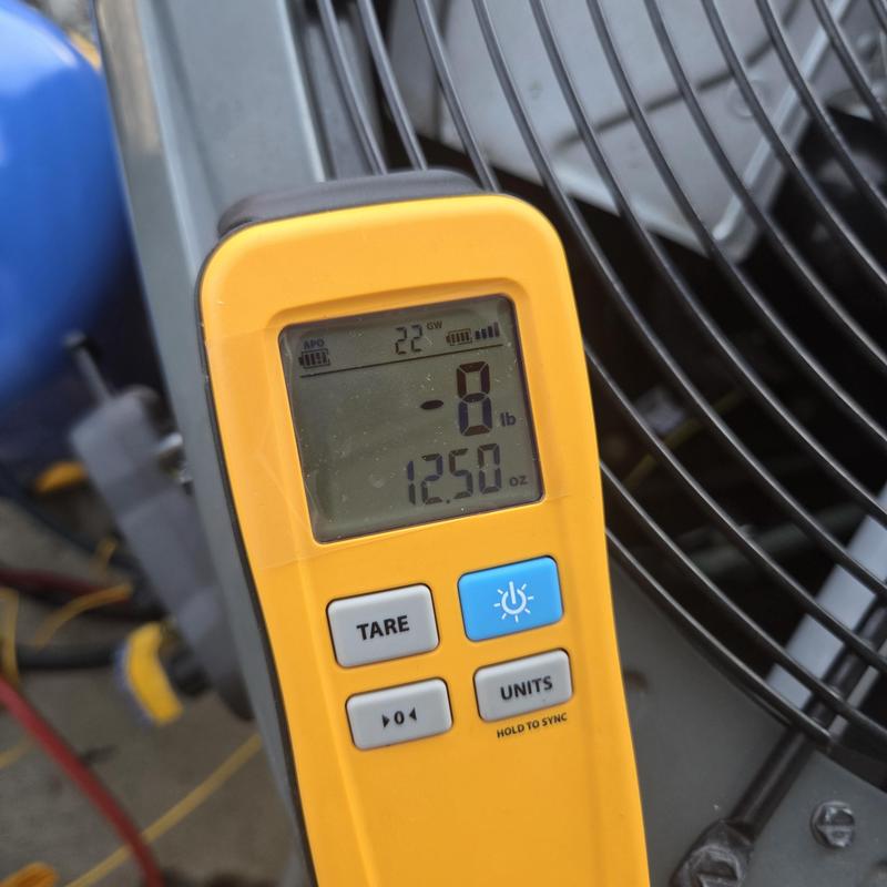 Refrigerant gauge display on HVAC condenser unit fan Refrigerant gauge display on HVAC condenser unit fan