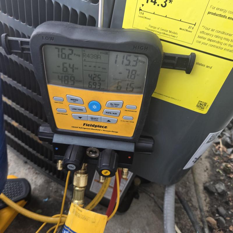 Refrigerant manifold gauge on AC unit outdoors Refrigerant manifold gauge on AC unit outdoors