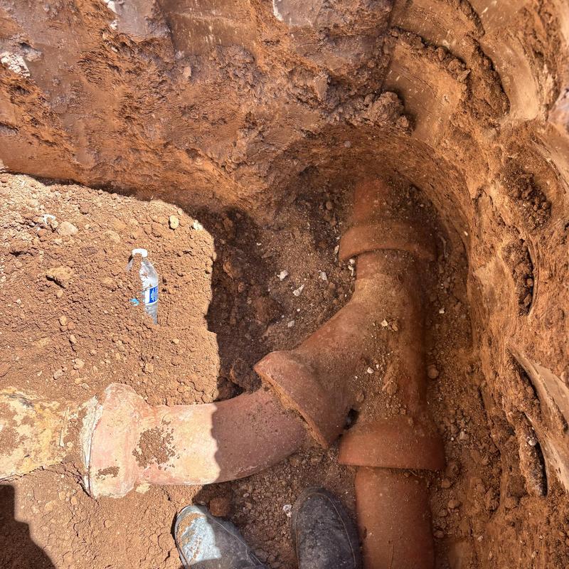Clay plumbing pipe underground with trench excavation