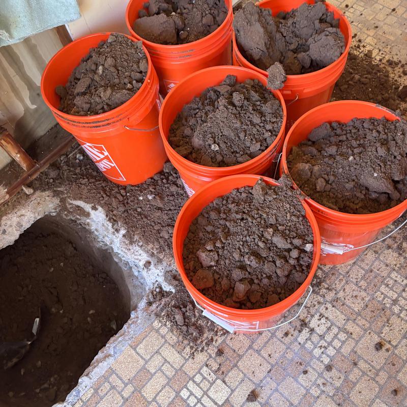 Floor excavation with buckets of soil during repipe