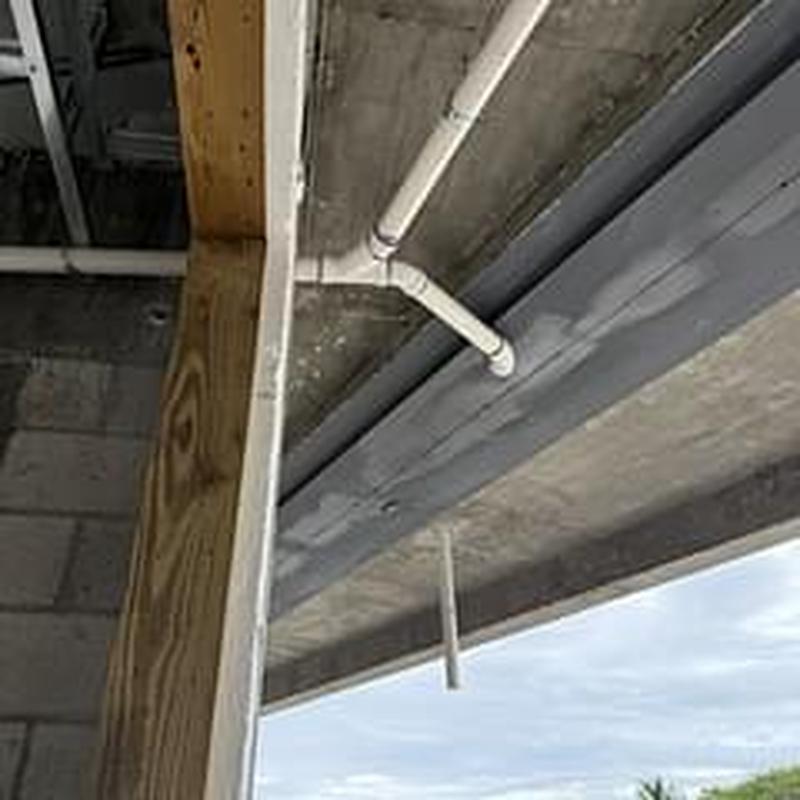 Drain line pipe installation under roof overhang