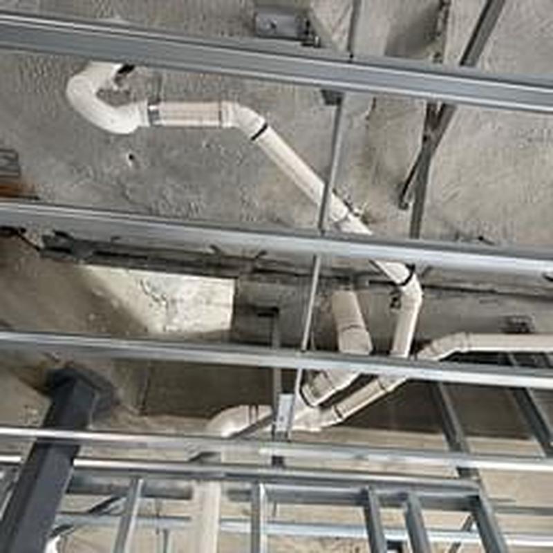 PVC drain piping installation inside ceiling framework