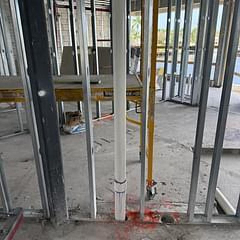 PVC drain pipe installation inside building frame