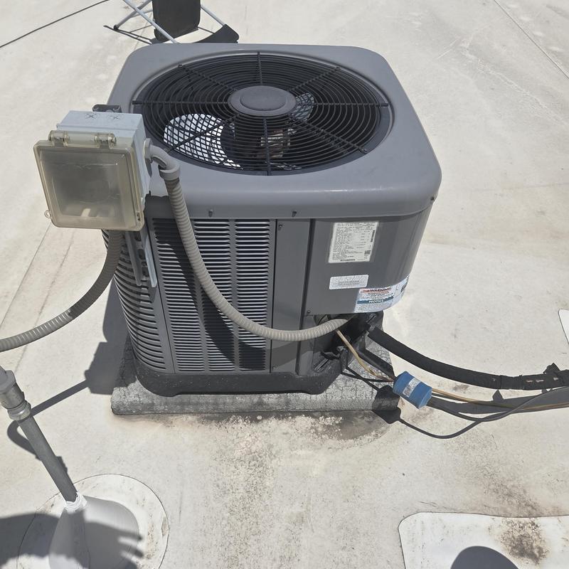 Air conditioning condenser unit on flat roof installation Air conditioning condenser unit on flat roof installation