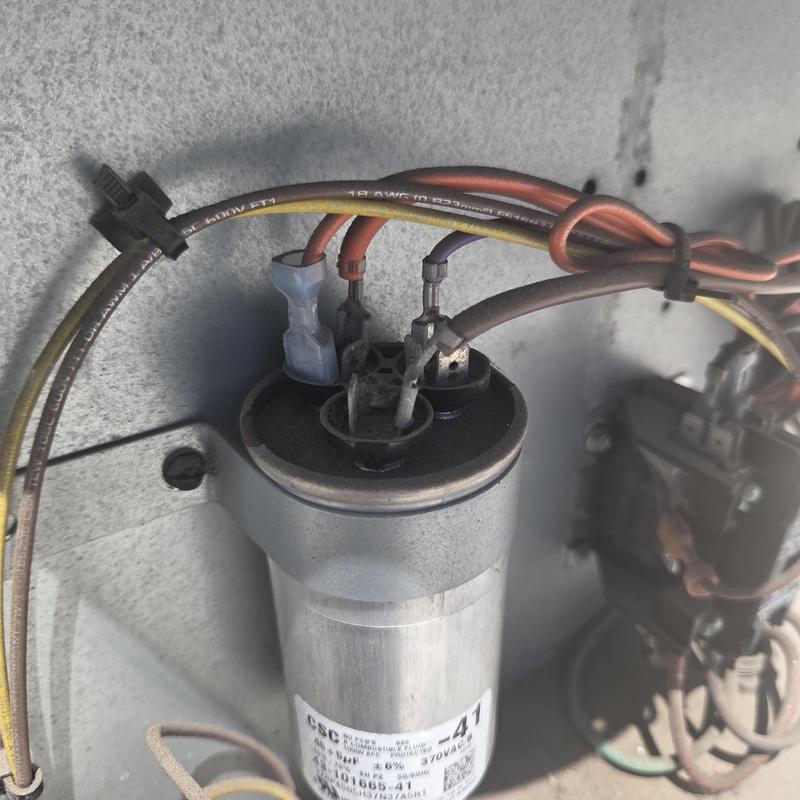 HVAC capacitor with connected wiring in metal panel HVAC capacitor with connected wiring in metal panel