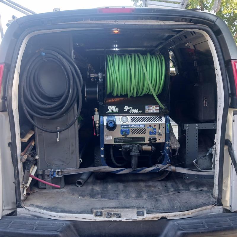 Sewer jetter machine with hoses inside service van