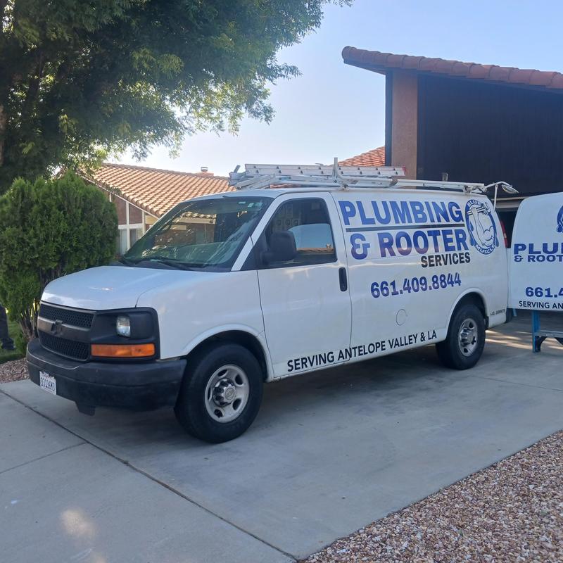 Plumbing and rooter service van parked on driveway