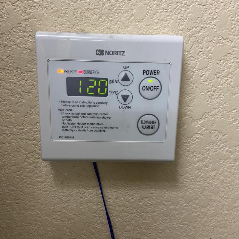 Tankless water heater control panel with active burner light Tankless water heater control panel with active burner light