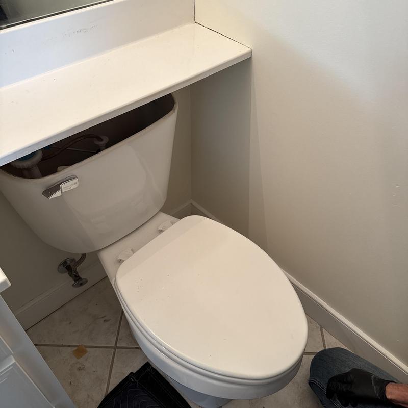 Toilet tank with open lid for leak inspection Toilet tank with open lid for leak inspection