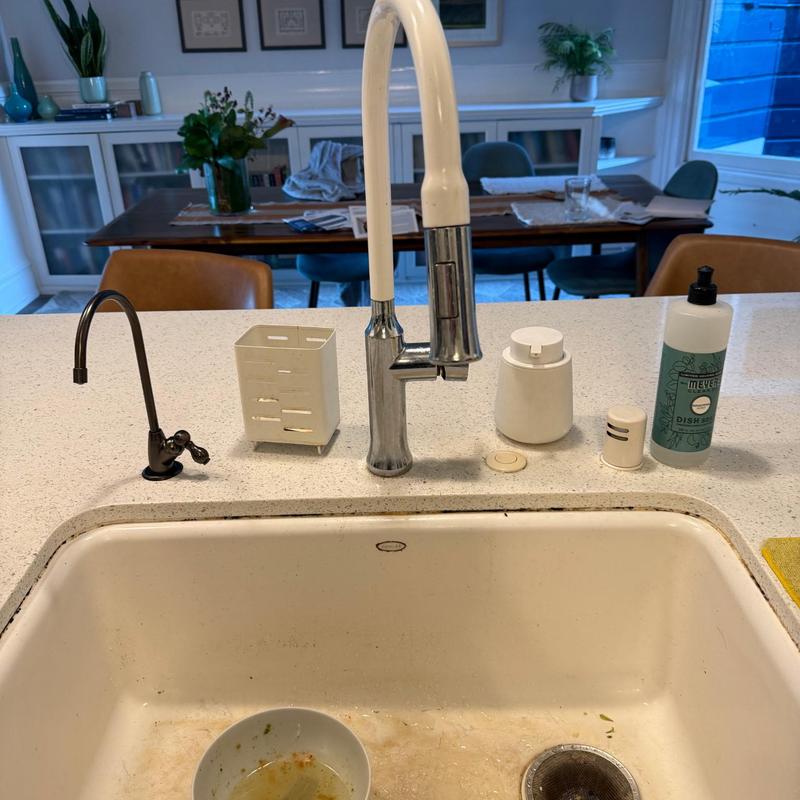 Kitchen faucet and soap dispenser on countertop