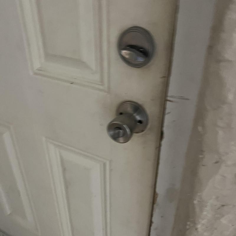 Door locks on white exterior door, rekeyed and replaced