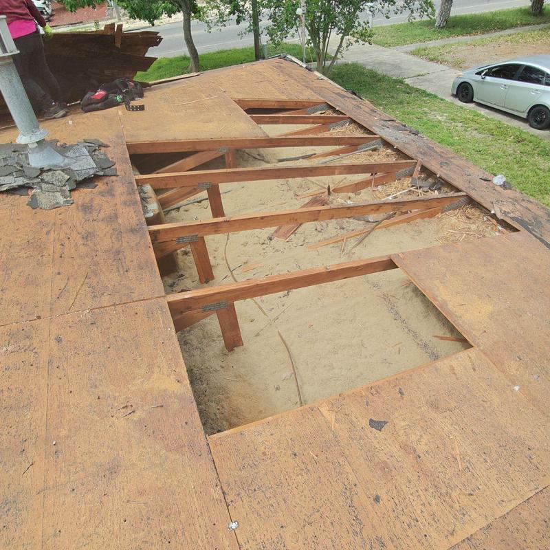 Roof decking removal showing wooden framing exposed Roof decking removal showing wooden framing exposed