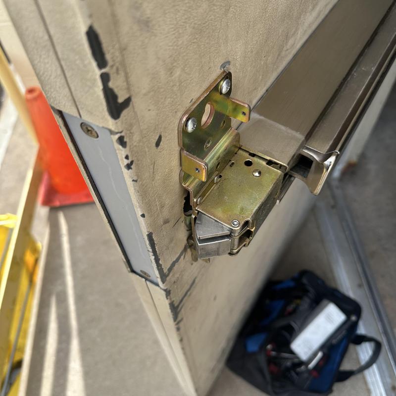 Exit device trim with key stuck and lock exposed on door