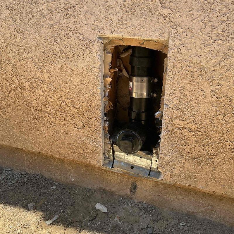 Drain pipe section with new fittings in wall cutout