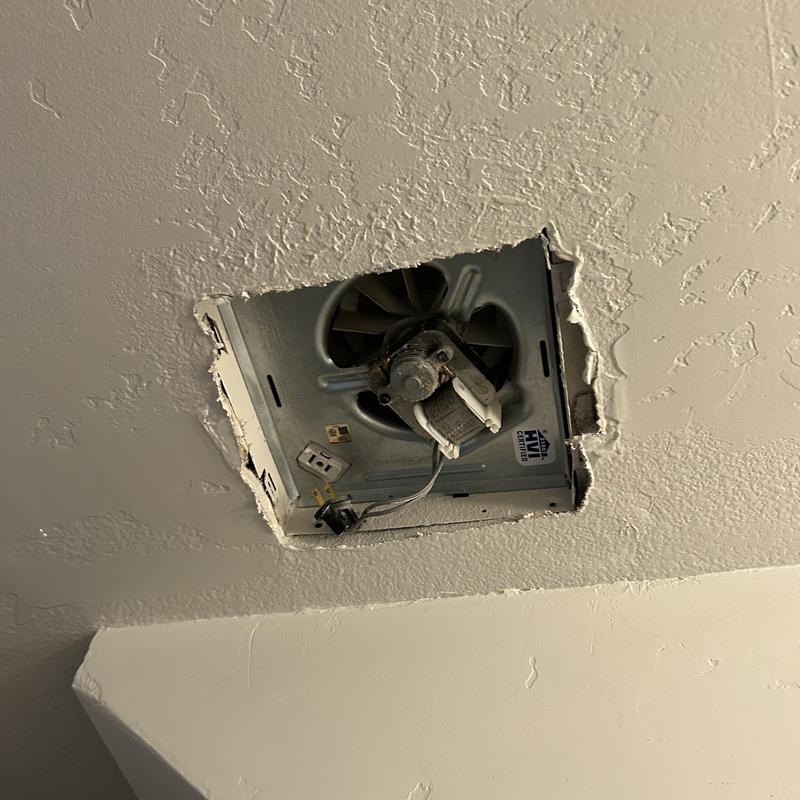 Bathroom exhaust fan housing removed from ceiling cavity Bathroom exhaust fan housing removed from ceiling cavity