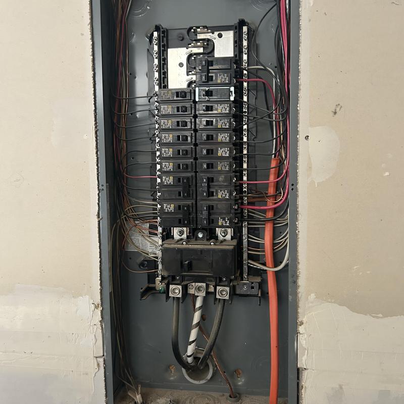 Electrical breaker panel with connected wiring inside wall Electrical breaker panel with connected wiring inside wall