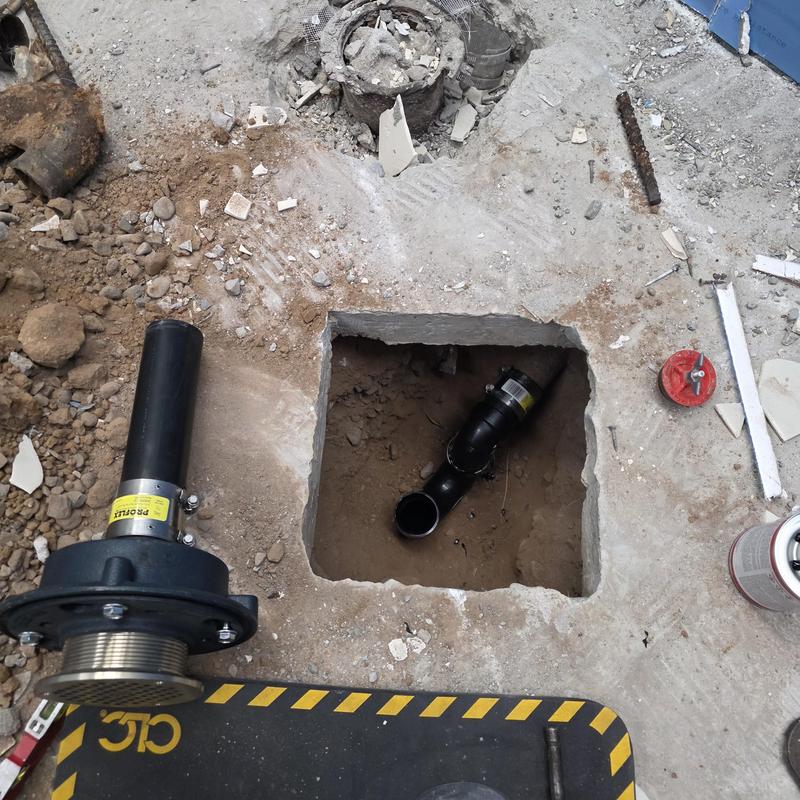 Floor drain with new ABS p-trap in concrete floor cutout Floor drain with new ABS p-trap in concrete floor cutout