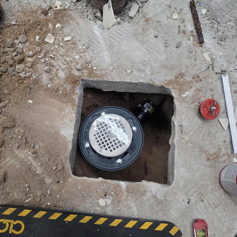 Floor drain with new ABS P-trap installed in concrete floor Floor drain with new ABS P-trap installed in concrete floor