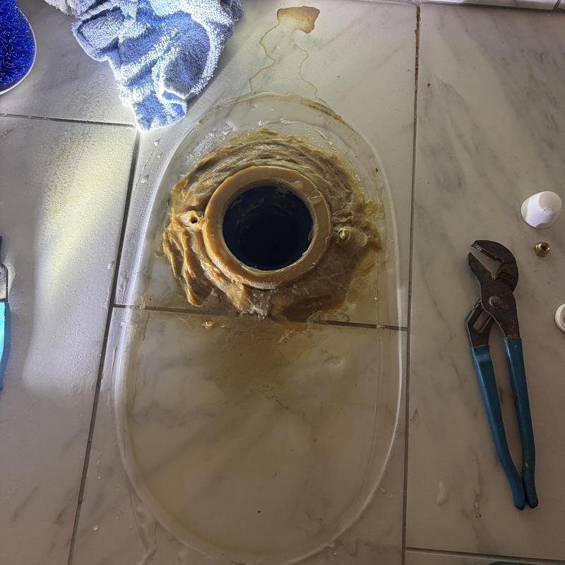Toilet flange with old wax seal removed on tiled floor Toilet flange with old wax seal removed on tiled floor