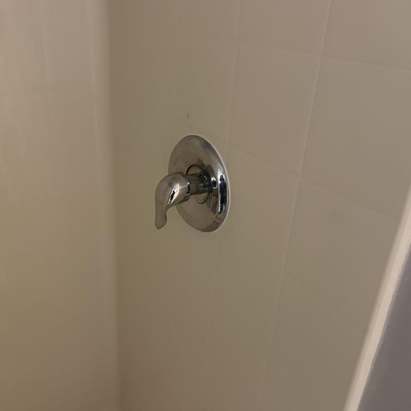 Shower valve handle on tiled wall Shower valve handle on tiled wall