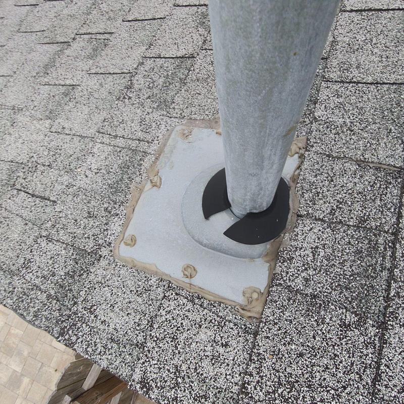 Pipe flashing on shingle roof with sealant applied