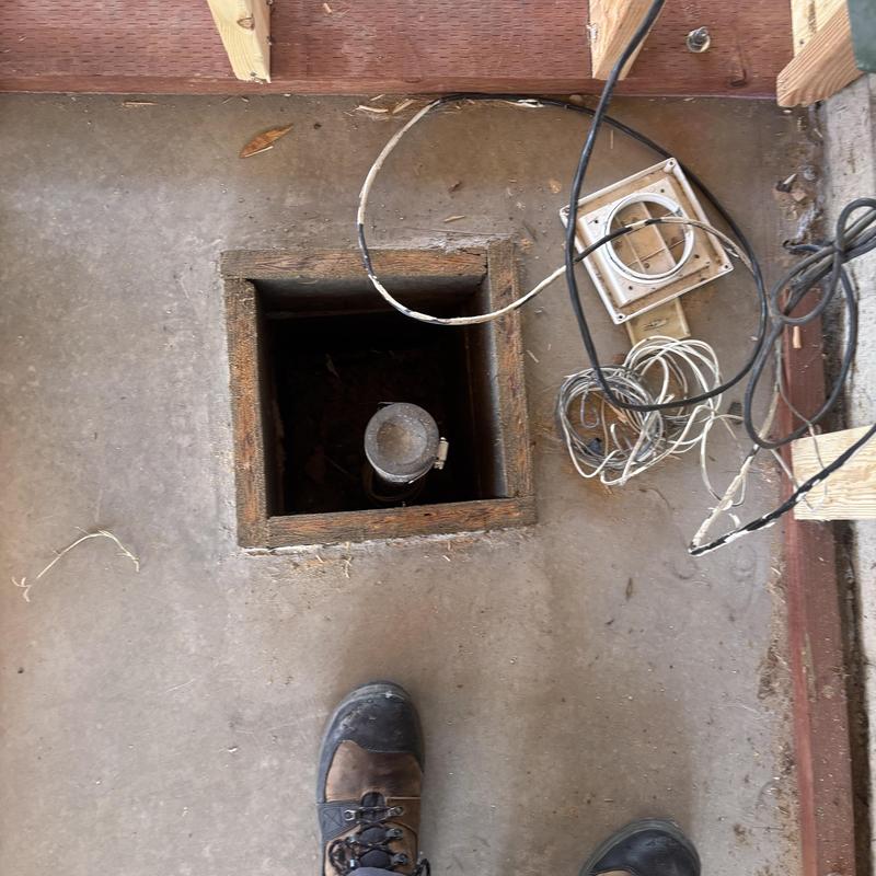 Water heater vent pipe in floor access with wiring nearby