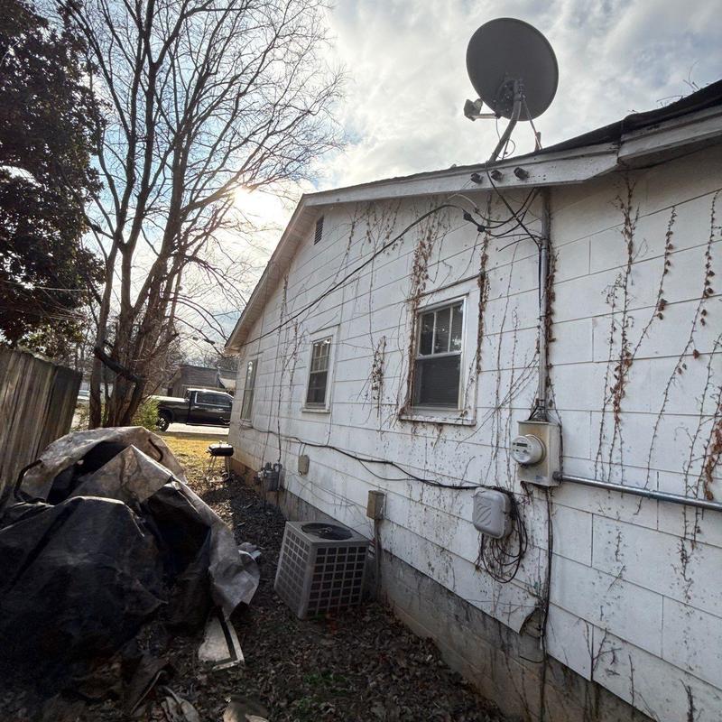 Satellite dish and exterior wall with wiring