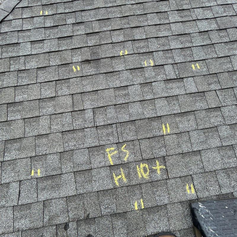 Roof shingles with marked hail damage inspection points