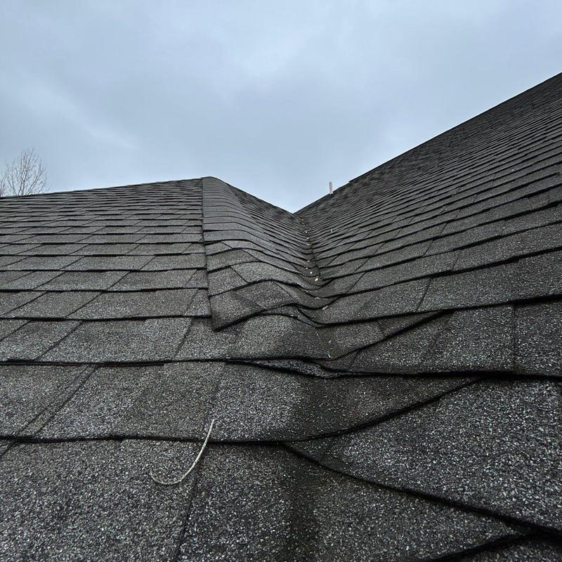 Roof shingles with hail damage and distortion