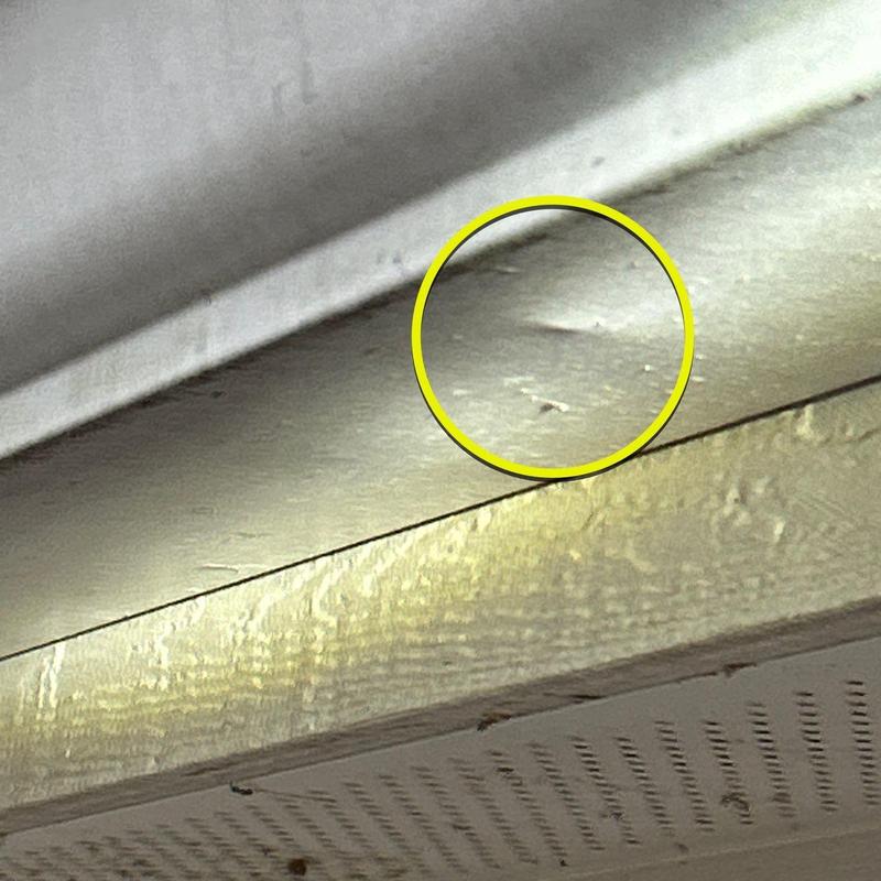 Roof fascia board with hail damage dents