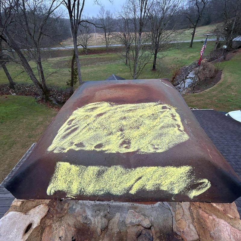 Chimney metal cap with rust and marked damage