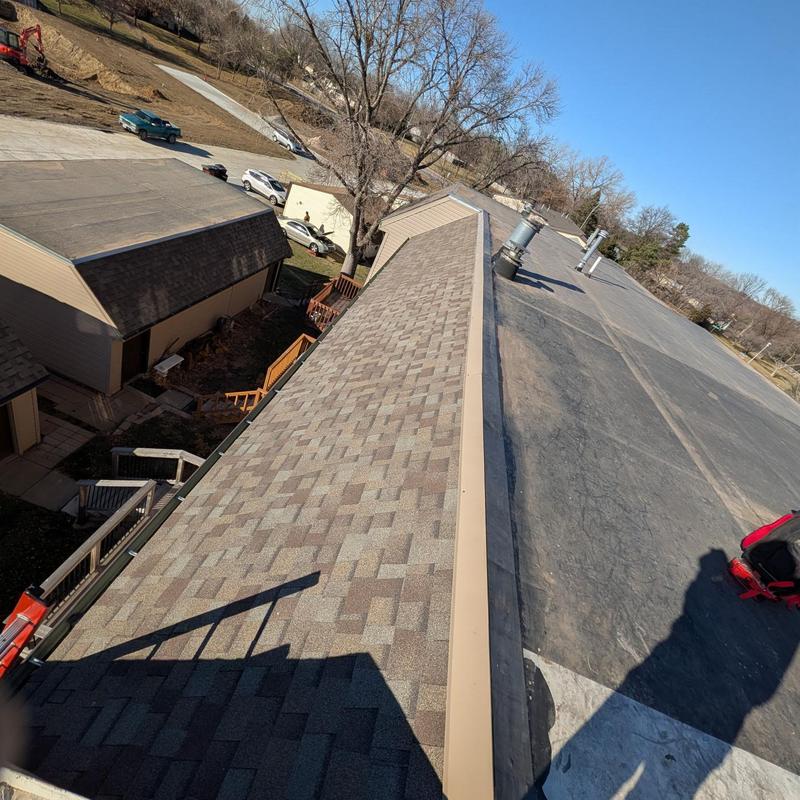 Asphalt shingle roof with EPDM cover strips installation