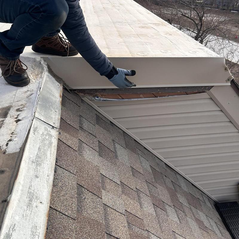 Metal roof edge flashing inspection with damaged panel